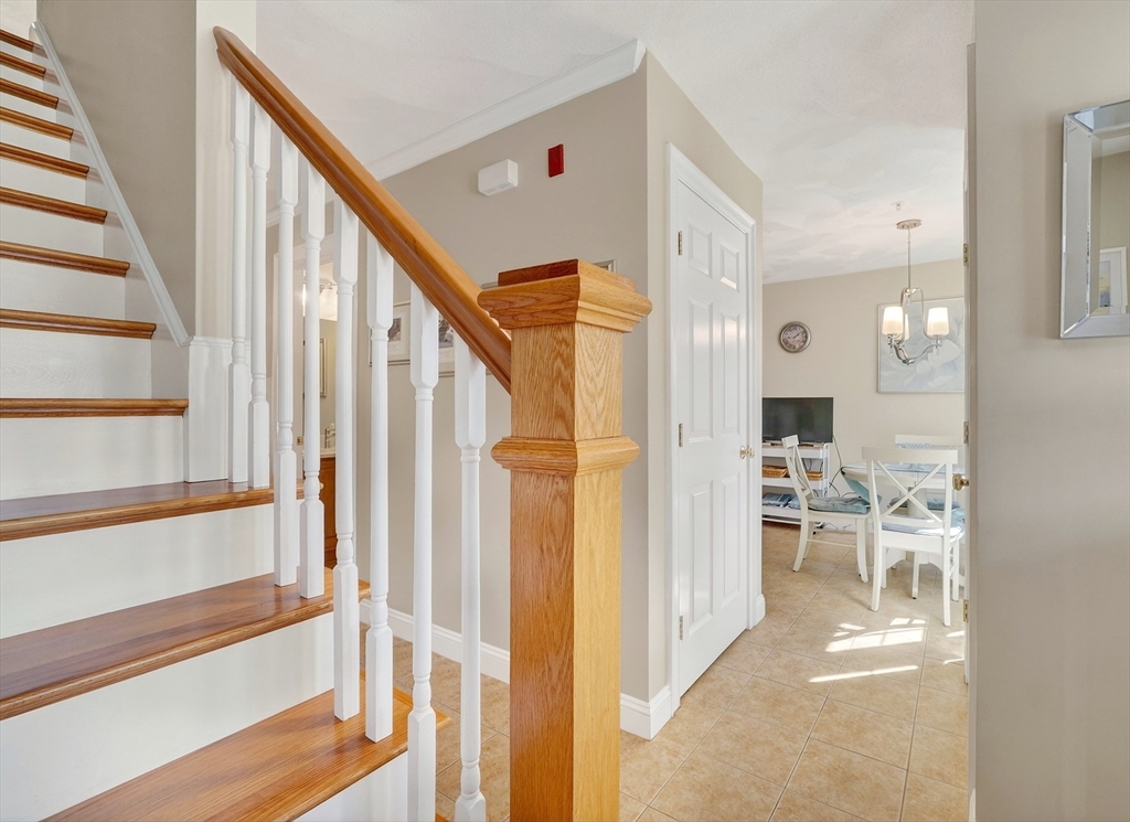 102 Central Street, Unit 5A Saugus, MA 01906 - Photo 2 of 31 a view of a hallway with wooden floor and staircase