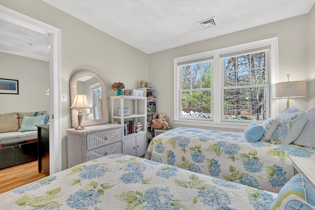102 Central Street, Unit 5A Saugus, MA 01906 - Photo 21 of 31 a bedroom with a large bed and wooden floor
