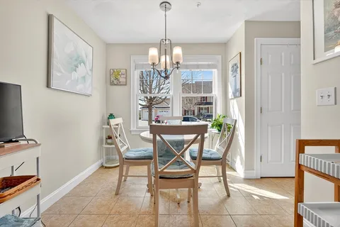 a view of a dining room with furniture and a chandelier