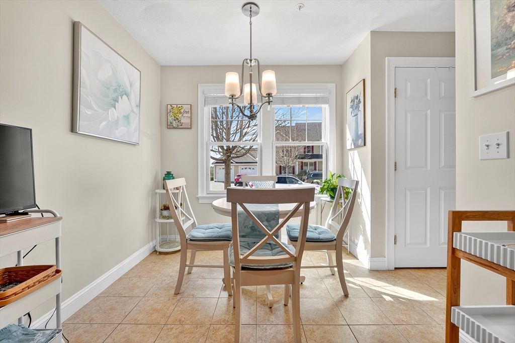 102 Central Street, Unit 5A Saugus, MA 01906 - Photo 4 of 31 a view of a dining room with furniture and a chandelier