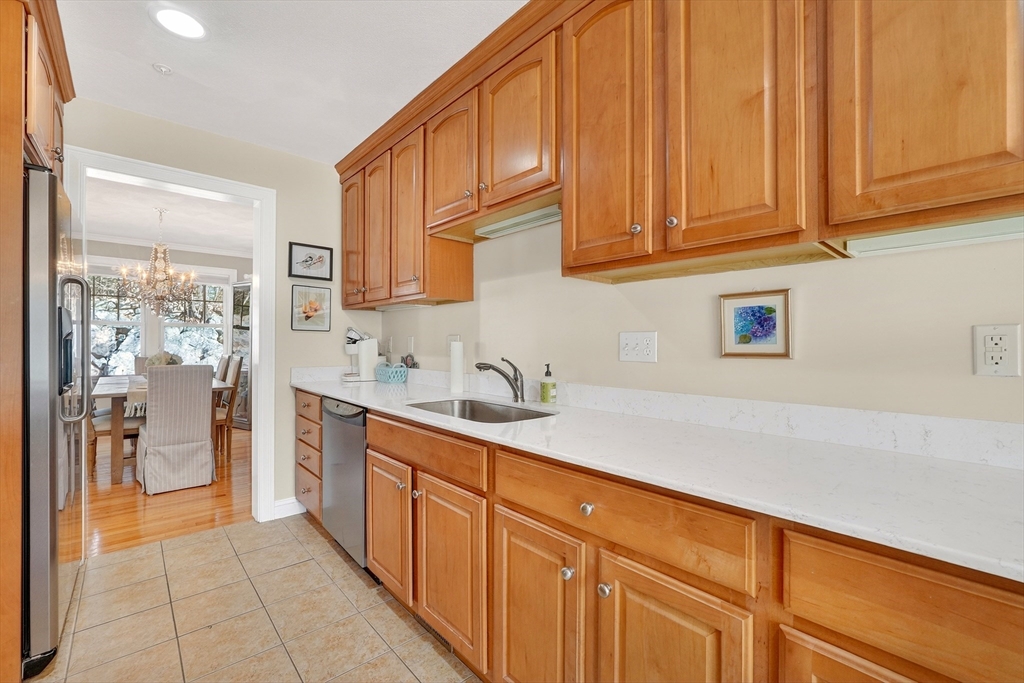 102 Central Street, Unit 5A Saugus, MA 01906 - Photo 5 of 31 a kitchen with stainless steel appliances granite countertop a sink and cabinets