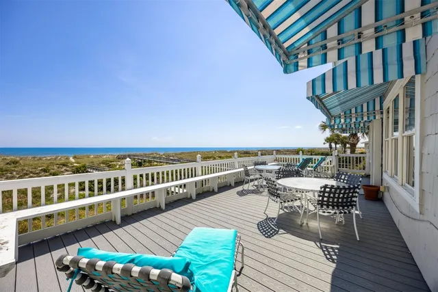 a view of a patio with couches table and chairs and potted plants