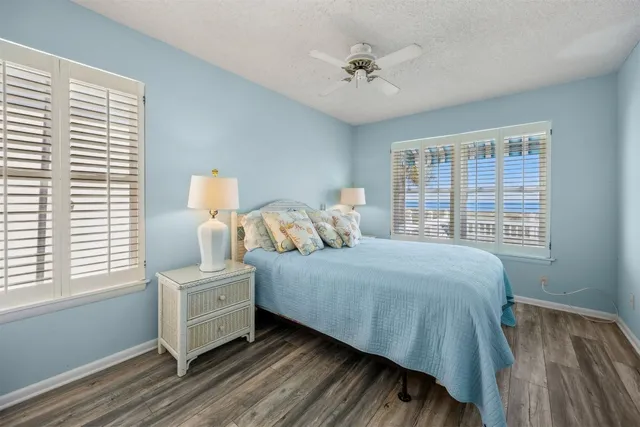 a bedroom with two beds and a large window