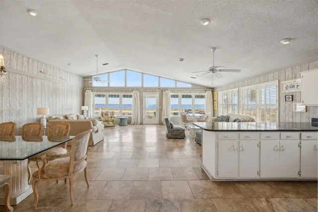a kitchen with granite countertop a sink and white cabinets