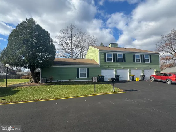 a view of a house with a swimming pool and a yard
