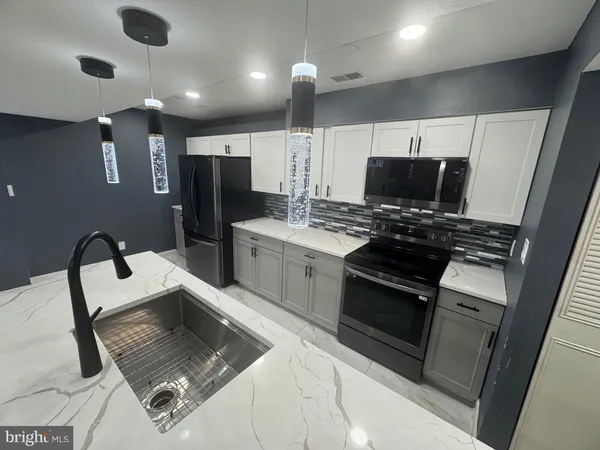 a kitchen with a stove and a refrigerator