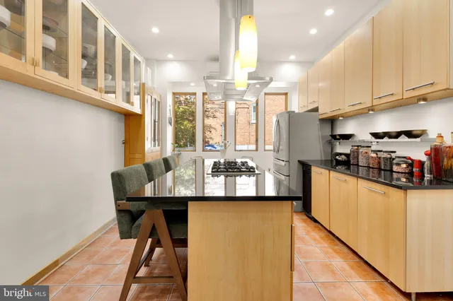 a kitchen with stainless steel appliances kitchen island granite countertop a sink and cabinets