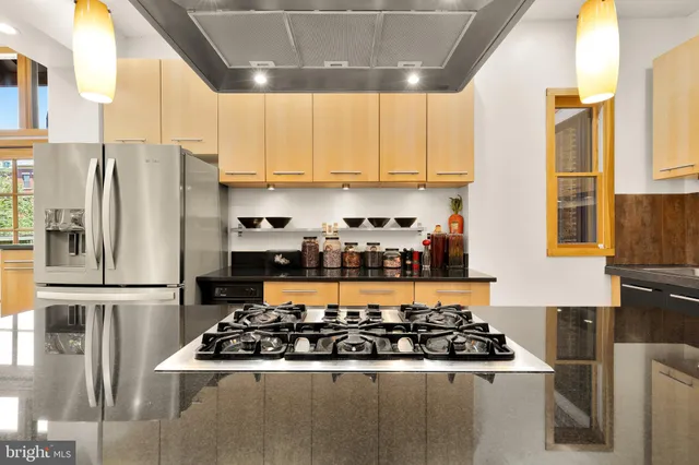 a kitchen with stainless steel appliances granite countertop a stove a refrigerator and a refrigerator