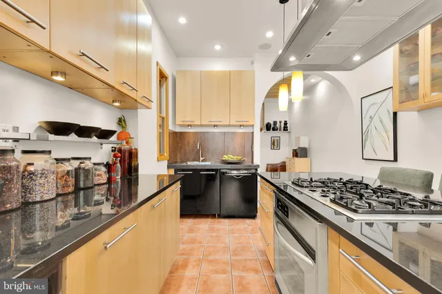 a kitchen with stainless steel appliances granite countertop a stove and a sink
