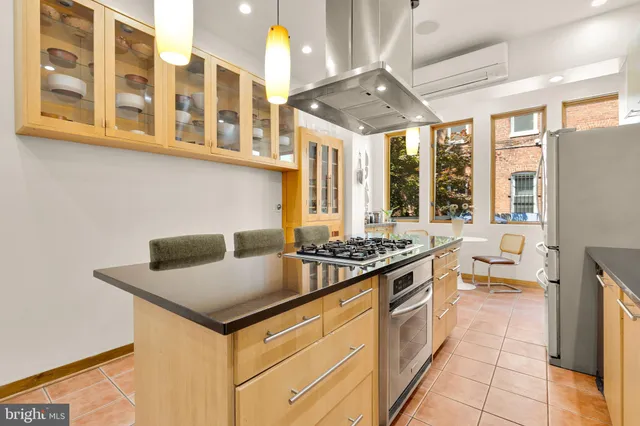 a kitchen with stainless steel appliances granite countertop a stove and a sink