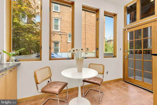 a dining room with furniture and a window