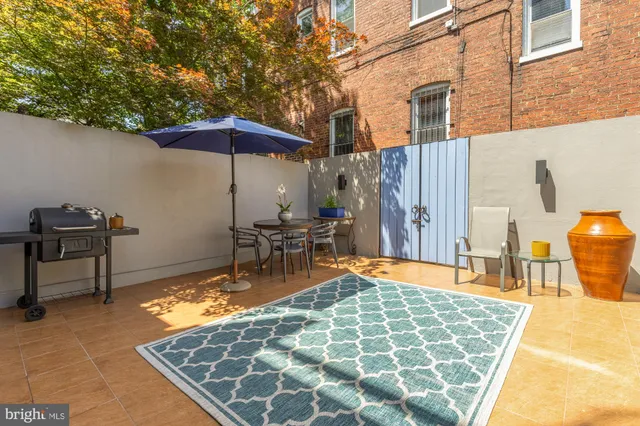 a backyard of a house with table and chairs