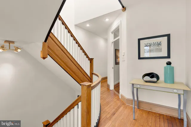 a view of entryway and hall with wooden floor