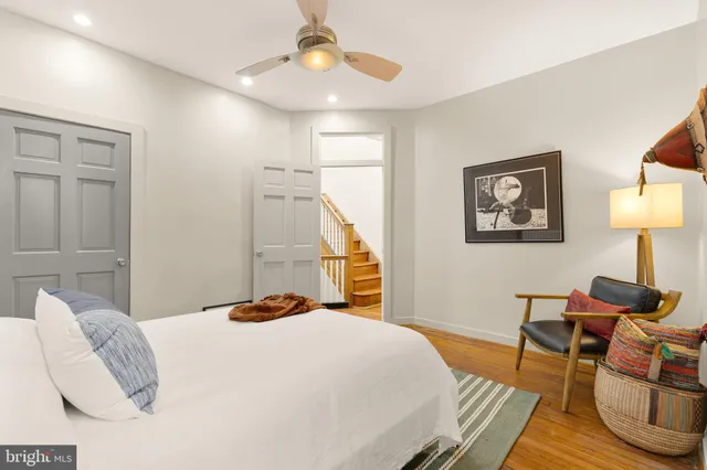 a kitchen with a refrigerator and white cabinets