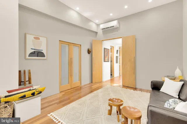 a large bedroom with bed and balcony