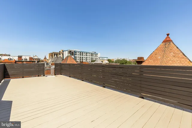 a living room with furniture a flat screen tv and lamp