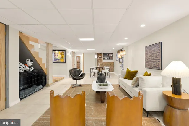 a living room with furniture a lamp and a chandelier