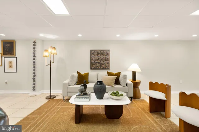 a living room with furniture and a dining table with wooden floor