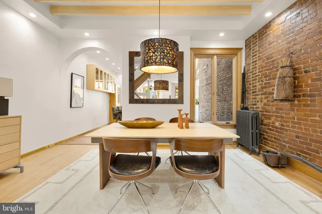 a dining room with granite countertop a table and chairs