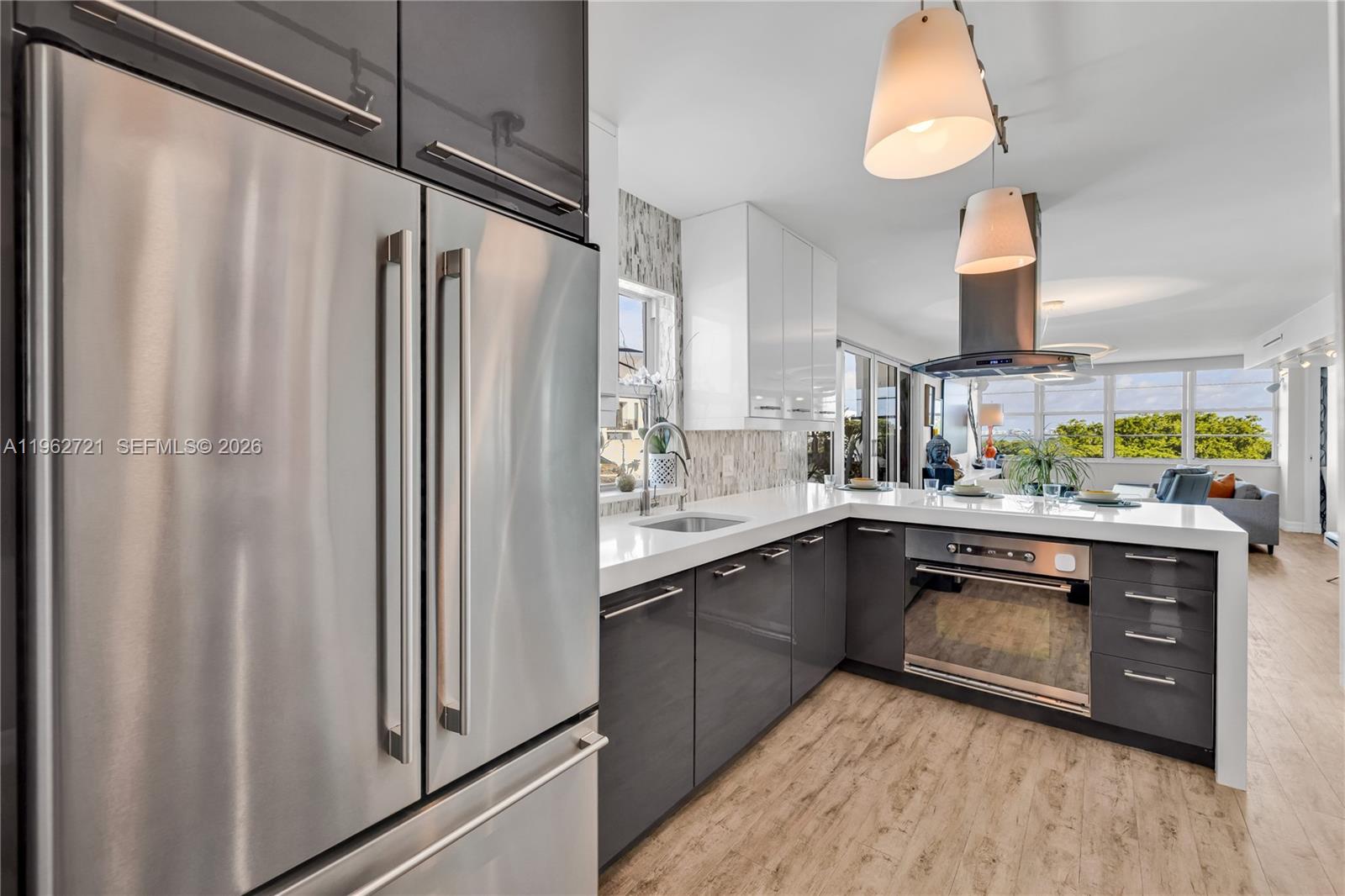 680 Northeast 64th Street, Unit APH3 Miami, FL 33138 - Photo 14 of 77 a kitchen with stainless steel appliances a refrigerator sink and cabinets