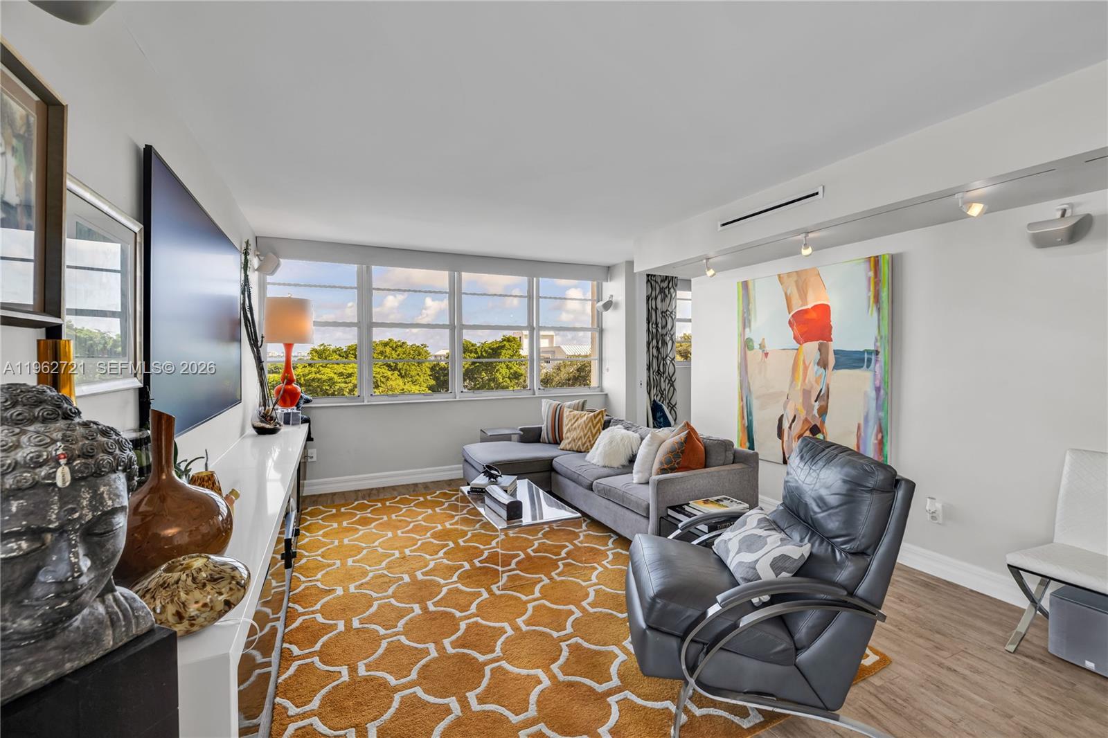 680 Northeast 64th Street, Unit APH3 Miami, FL 33138 - Photo 22 of 77 a living room with furniture and a large window