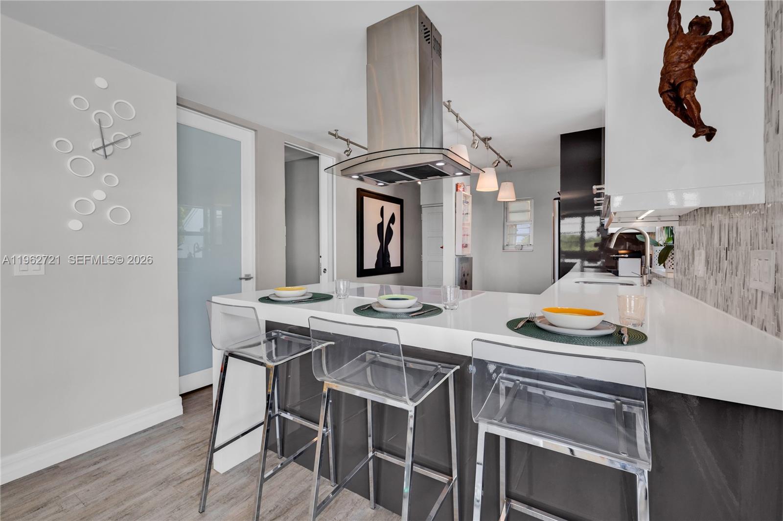 680 Northeast 64th Street, Unit APH3 Miami, FL 33138 - Photo 27 of 77 a kitchen with a sink and cabinets