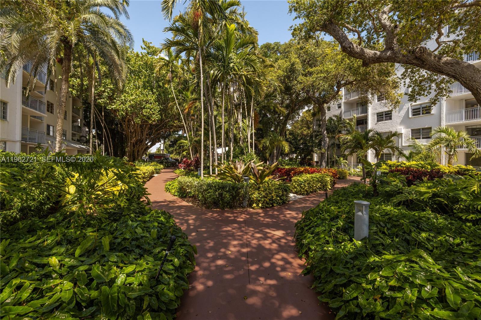 680 Northeast 64th Street, Unit APH3 Miami, FL 33138 - Photo 35 of 77 a view of a large yard with plants and large trees