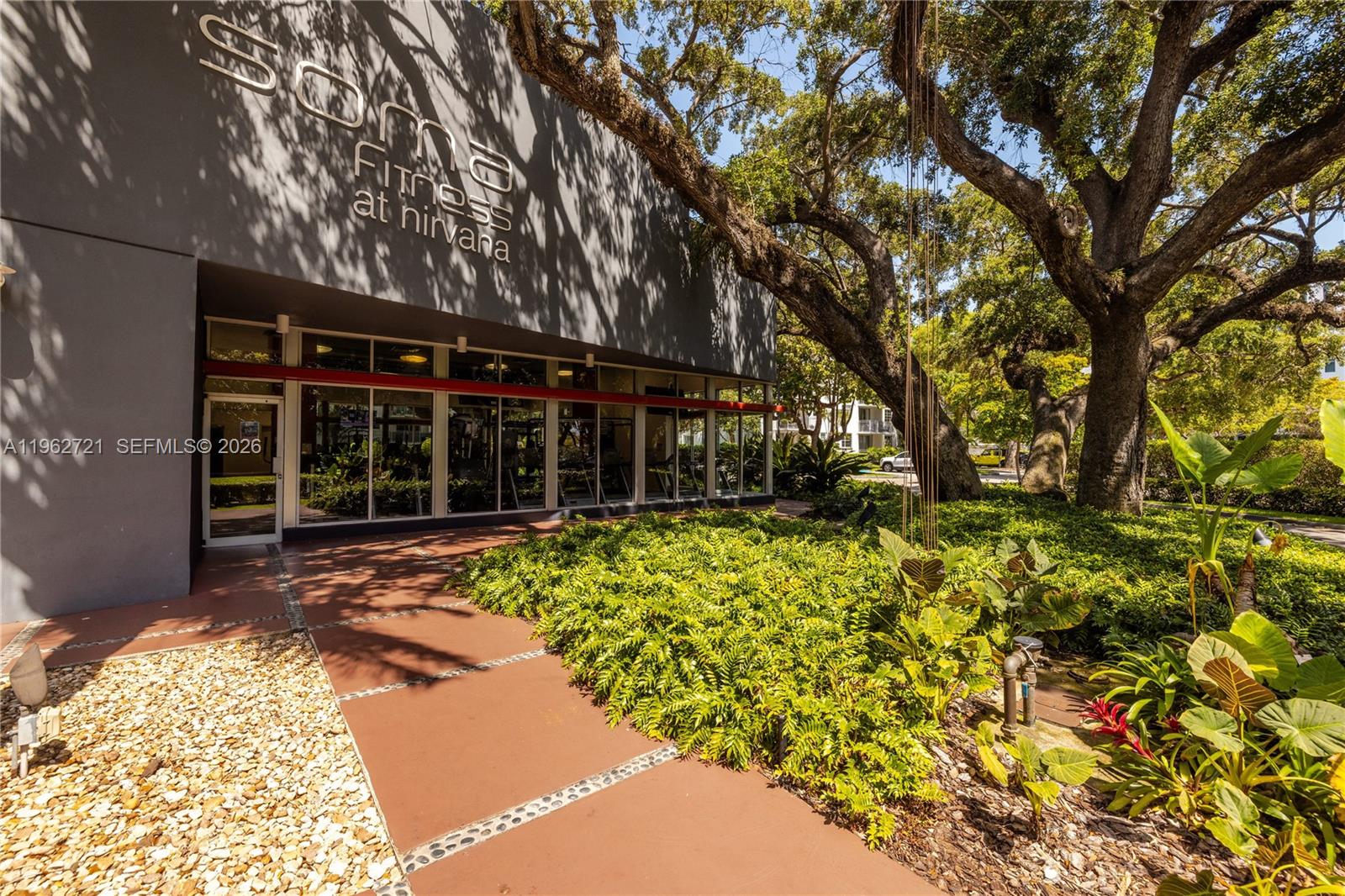 680 Northeast 64th Street, Unit APH3 Miami, FL 33138 - Photo 54 of 77 front view of a house with a large tree