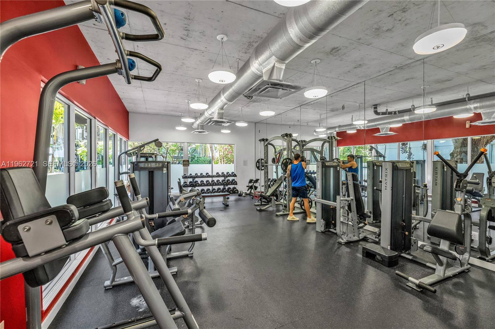680 Northeast 64th Street, Unit APH3 Miami, FL 33138 - Photo 59 of 77 a view of a room with gym equipment