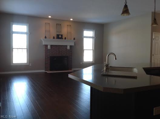 4631 Paxton Road Akron, OH 44321 - Photo 8 of 18 Island to Family room/wood burning fireplace with gas starter and extra high windows
