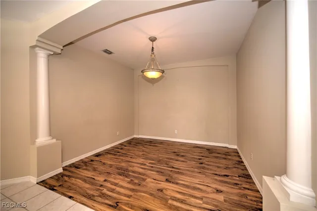 a view of a room with wooden floor and white walls