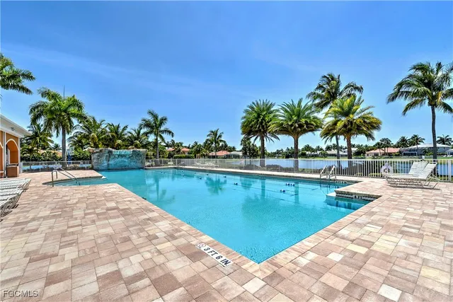 a view of swimming pool with outdoor seating and plants