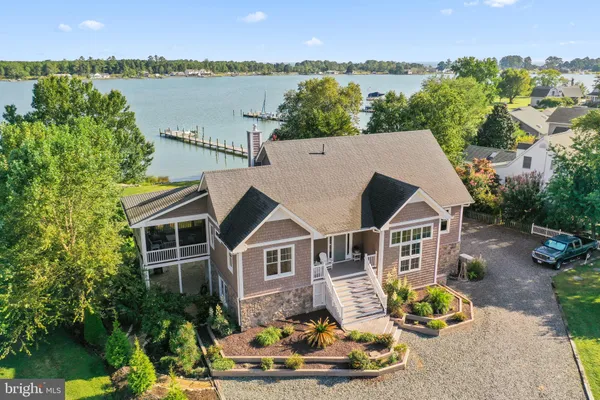 a aerial view of a house with a yard and balcony