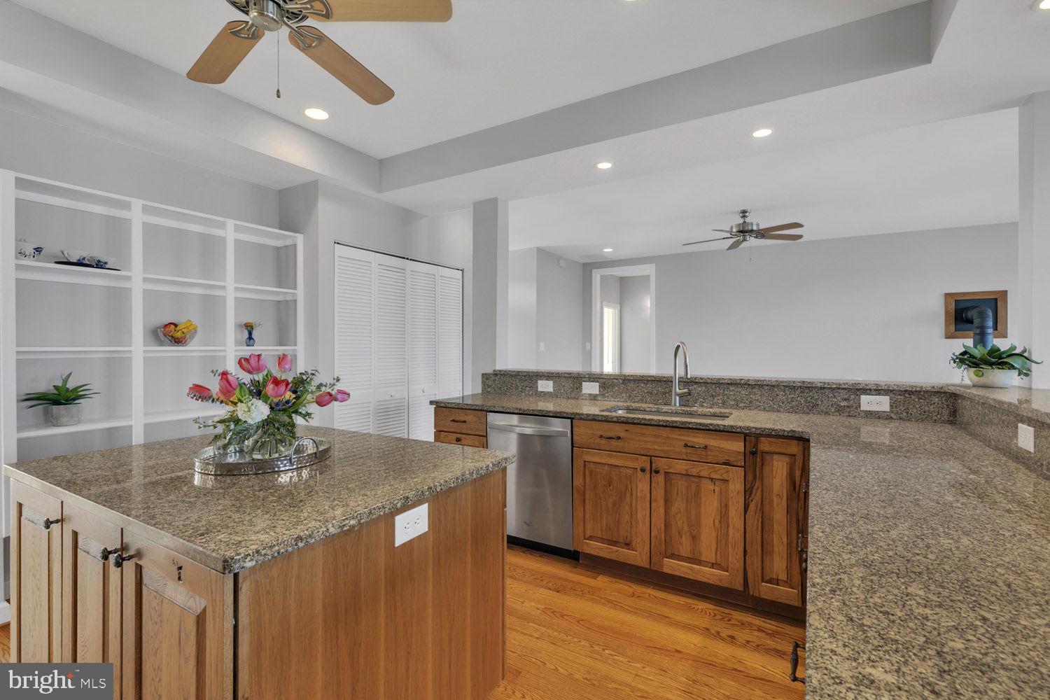 1469 Cowart Road Lottsburg, VA 22511 - Photo 22 of 54 a kitchen with stainless steel appliances granite countertop stove cabinets and sink