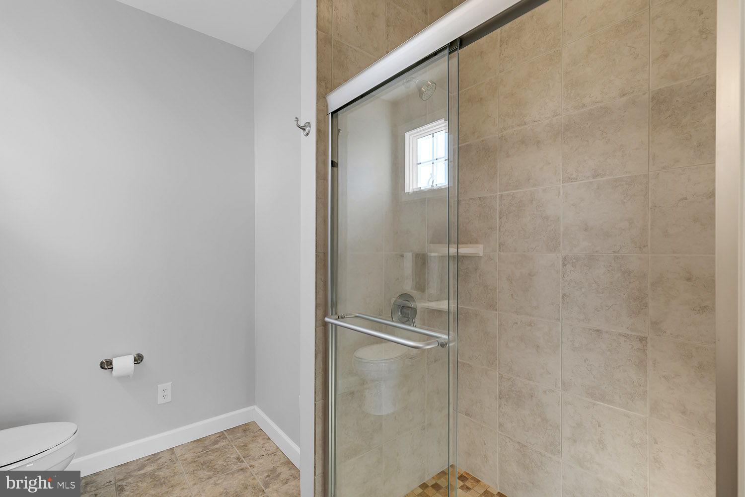 1469 Cowart Road Lottsburg, VA 22511 - Photo 30 of 54 a bathroom with a granite countertop shower and a toilet