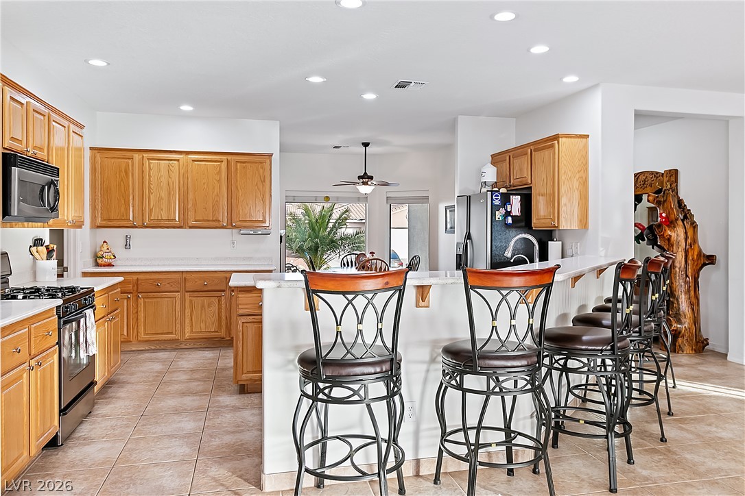 3505 Cottage Meadow Way Laughlin, NV 89029 - Photo 12 of 98 Closer angle of the Kitchen with breakfast bar and tile flooring.