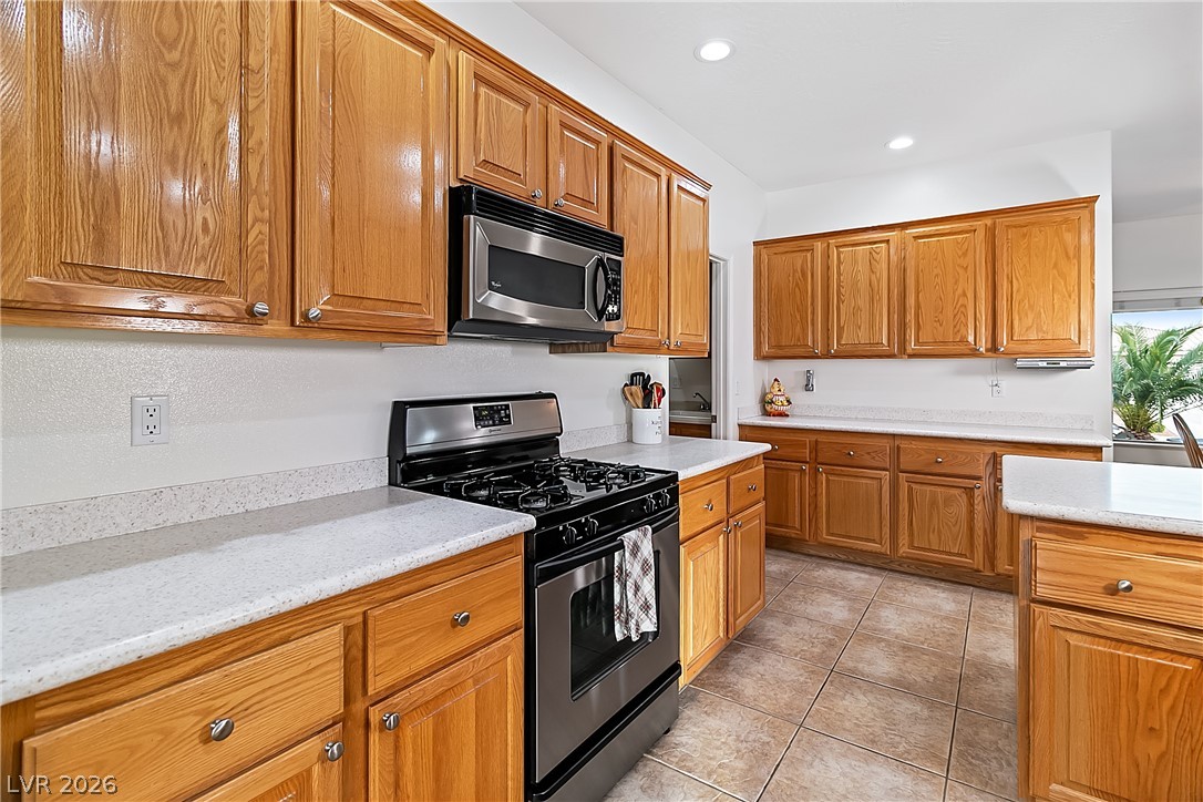 3505 Cottage Meadow Way Laughlin, NV 89029 - Photo 17 of 98 The Kitchen has a stainless steel gas stove-top oven, and a stainless steel microwave above.