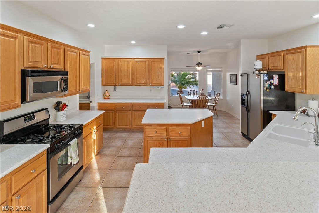 3505 Cottage Meadow Way Laughlin, NV 89029 - Photo 6 of 98 The Kitchen has a stainless steel gas stove-top oven and stainless steel microwave.