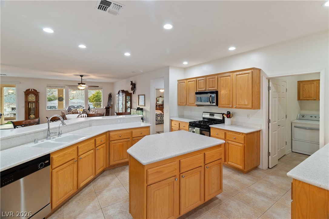 3505 Cottage Meadow Way Laughlin, NV 89029 - Photo 8 of 98 Alternate angle of the Kitchen from the breakfast nook area, showcasing the multiple countertops and plentiful wood cabinets.