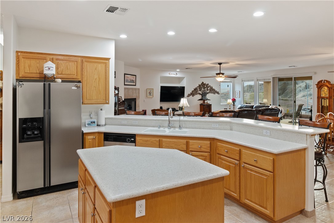 3505 Cottage Meadow Way Laughlin, NV 89029 - Photo 10 of 98 Alternate angle of the Kitchen with stainless steel fridge / freezer, and Island.