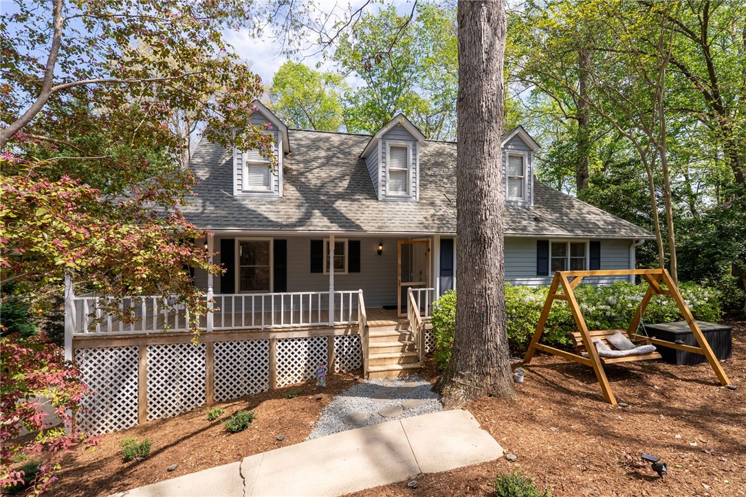 1002 Whitfield Point Road Anderson, SC 29626 - Photo 14 of 49 This charming home offers a welcoming facade with a cozy porch and lush surrounding greenery.