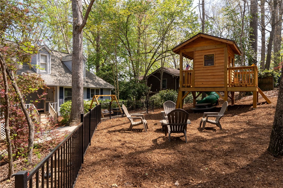 1002 Whitfield Point Road Anderson, SC 29626 - Photo 15 of 49 This private yard offers outdoor recreation and relaxation, complete with a charming playhouse and inviting seating.