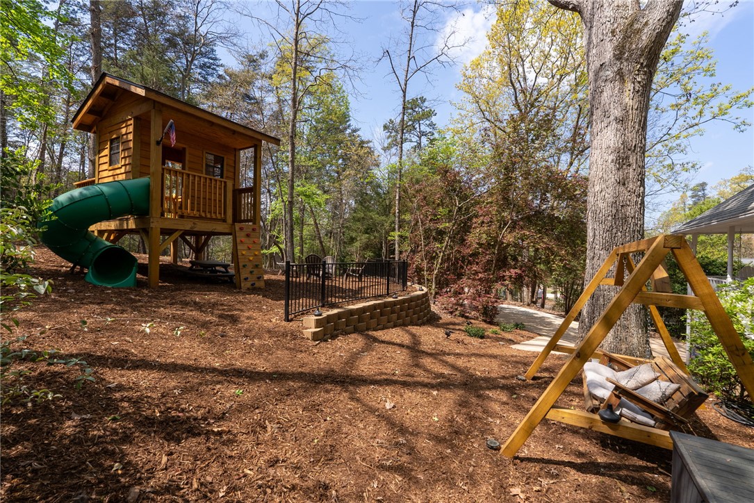 1002 Whitfield Point Road Anderson, SC 29626 - Photo 17 of 49 This spacious yard offers a charming playhouse, perfect for outdoor fun.