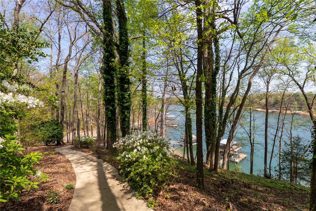 1002 Whitfield Point Road Anderson, SC 29626 - Photo 18 of 49 A tranquil pathway meanders through lush trees, leading to picturesque lake views and private docks.