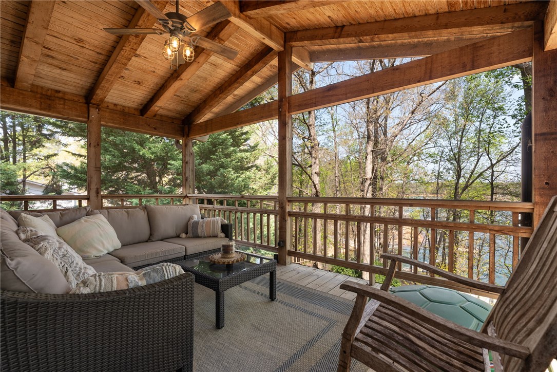 1002 Whitfield Point Road Anderson, SC 29626 - Photo 38 of 49 Enjoy tranquil moments and verdant views from this inviting porch, perfect for relaxation.