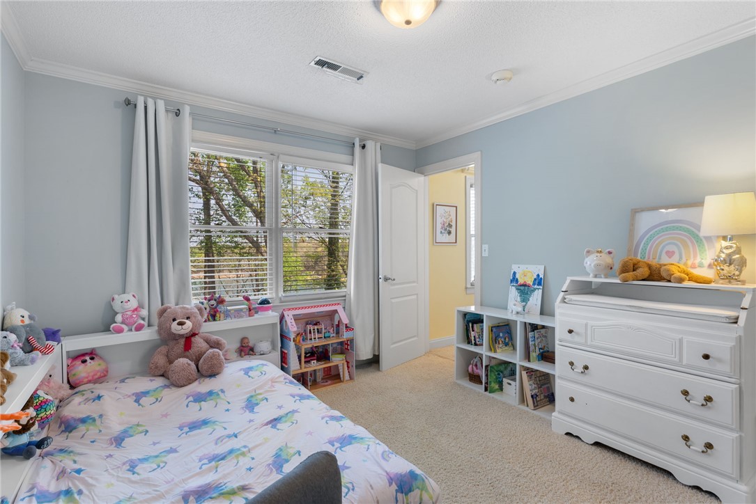 1002 Whitfield Point Road Anderson, SC 29626 - Photo 42 of 49 This inviting bedroom features soft carpeting, ample natural light, and classic crown molding.