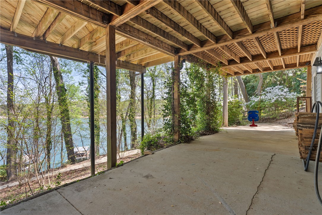 1002 Whitfield Point Road Anderson, SC 29626 - Photo 45 of 49 This covered patio offers serene water views, creating an inviting outdoor retreat.