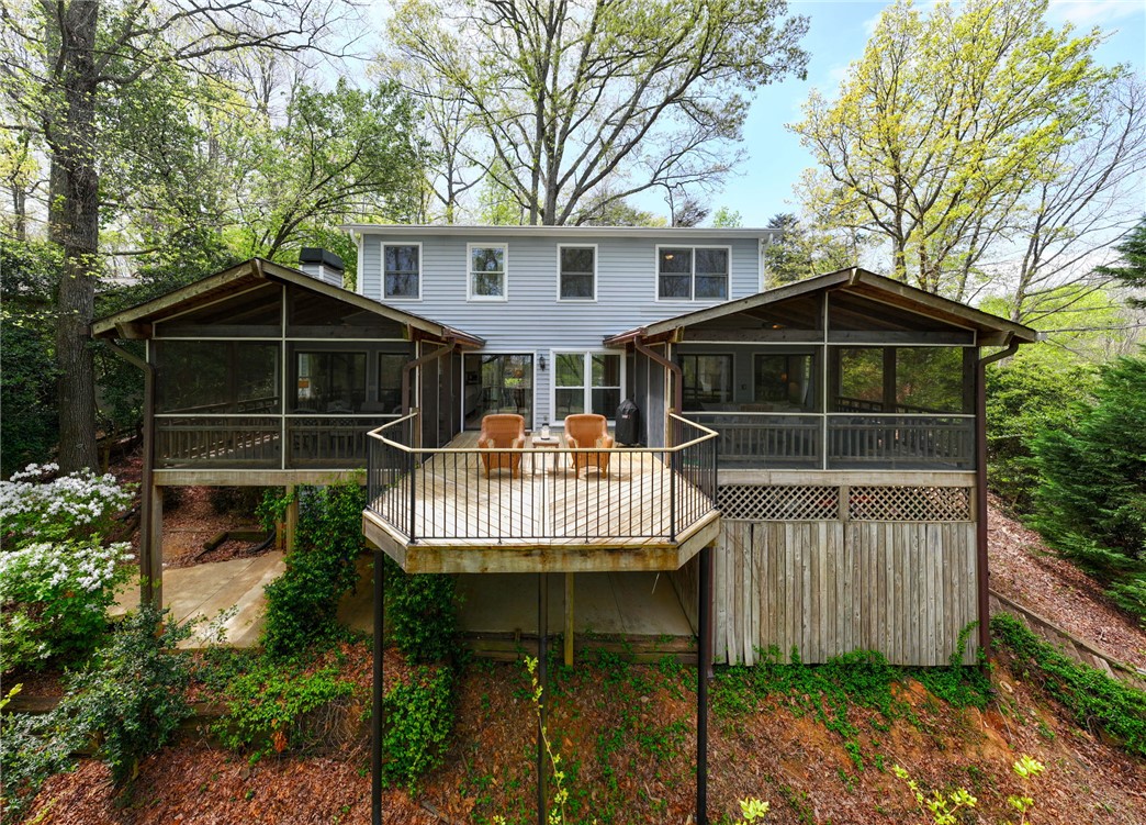1002 Whitfield Point Road Anderson, SC 29626 - Photo 9 of 49 This home features a large deck with two screened-in porches, providing a serene outdoor living experience.