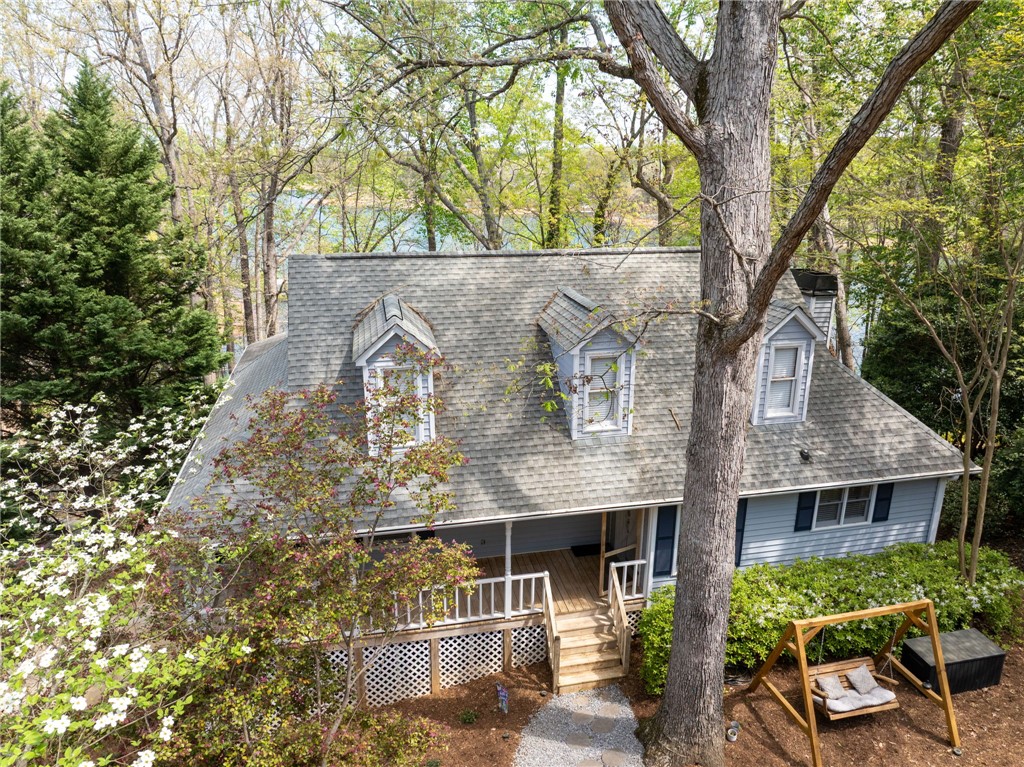 1002 Whitfield Point Road Anderson, SC 29626 - Photo 10 of 49 This charming lakeside home offers a welcoming facade with a quaint front porch and lush greenery.