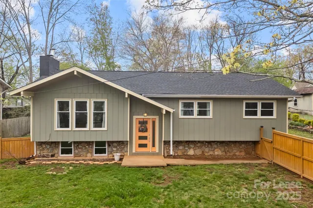 a front view of a house with a yard table and chairs